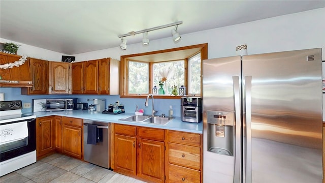 9447 County Route 75, Pulteney, NY 14418 - kitchen with appliances with stainless steel finishes, brown cabinetry, light countertops, track lighting, and light tile patterned floors