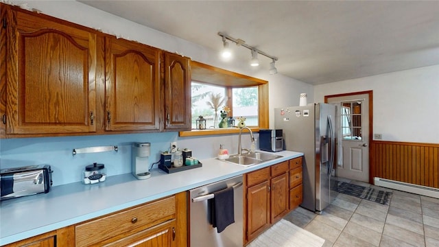 9447 County Route 75, Pulteney, NY 14418 - kitchen with appliances with stainless steel finishes, a baseboard heating unit, light countertops, wainscoting, and brown cabinetry