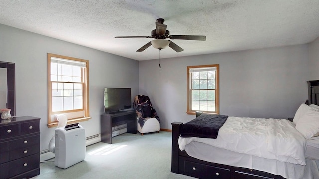 9447 County Route 75, Pulteney, NY 14418 - bedroom with a baseboard heating unit, light colored carpet, a ceiling fan, and a textured ceiling