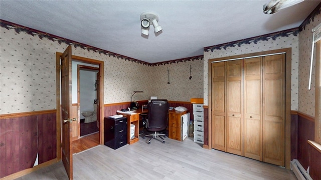 9447 County Route 75, Pulteney, NY 14418 - office space featuring wainscoting, a baseboard heating unit, light wood-style flooring, wallpapered walls, and wooden walls