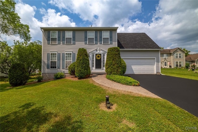 110 Clark Cir, Lenox, NY 13032 - colonial home with asphalt driveway, an attached garage, and a front lawn