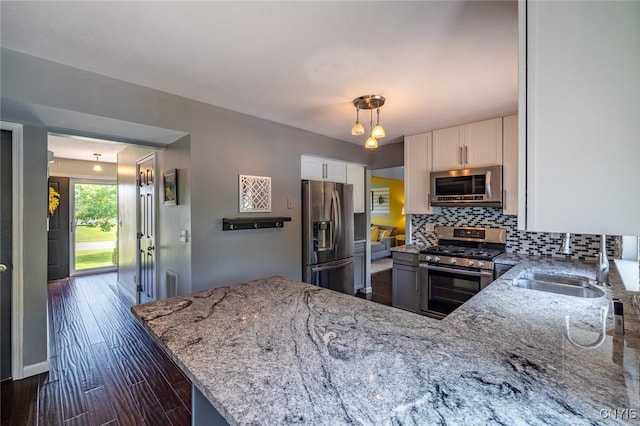 110 Clark Cir, Lenox, NY 13032 - kitchen with appliances with stainless steel finishes, light stone countertops, backsplash, white cabinets, and dark wood-style flooring