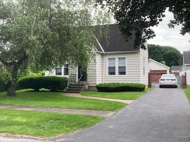 820 James St, Utica, NY 13501 - view of front of property with a front lawn, a garage, and roof with shingles