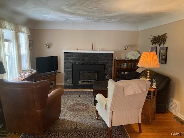820 James St, Utica, NY 13501 - living room with wood finished floors and a glass covered fireplace