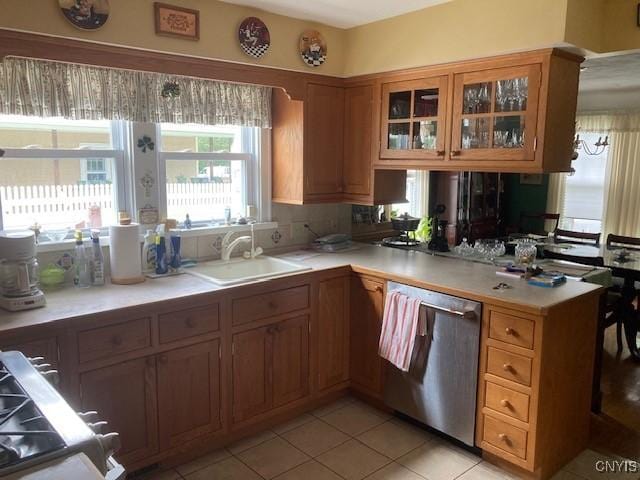 820 James St, Utica, NY 13501 - kitchen with stainless steel dishwasher, light countertops, glass insert cabinets, light tile patterned floors, and a peninsula