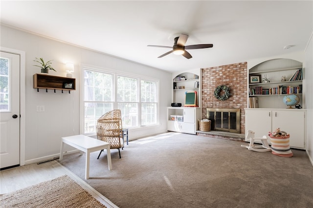 7 Chipping Rdg, Perinton, NY 14450 - sitting room with plenty of natural light, a ceiling fan, built in shelves, and a fireplace