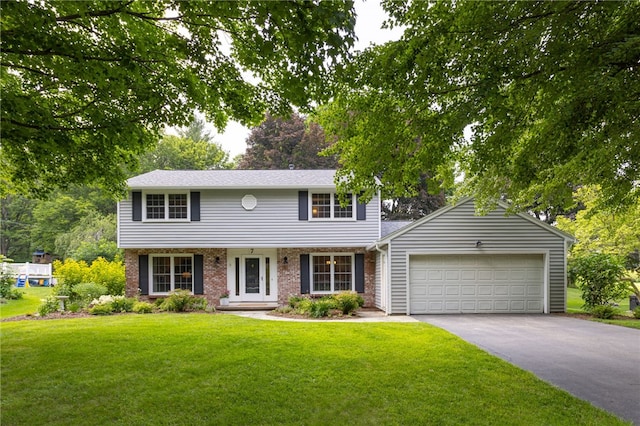 7 Chipping Rdg, Perinton, NY 14450 - colonial house with driveway, a front yard, an attached garage, and brick siding