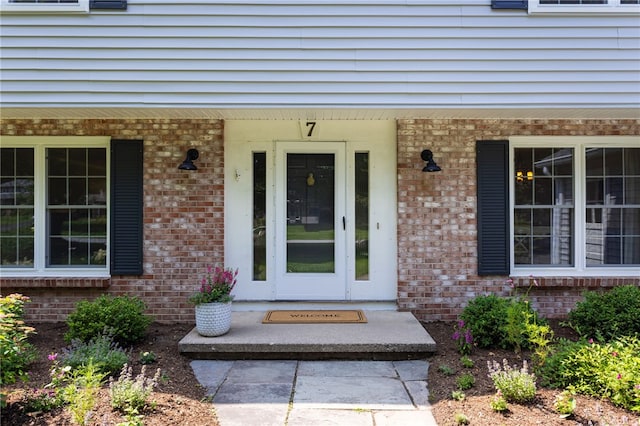 7 Chipping Rdg, Perinton, NY 14450 - view of exterior entry featuring a porch and brick siding