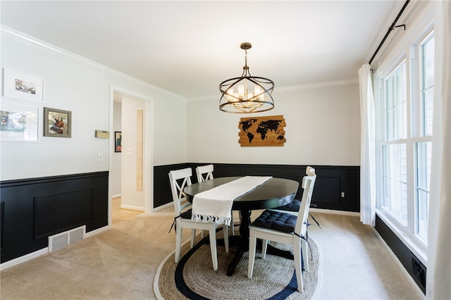 7 Chipping Rdg, Perinton, NY 14450 - dining area with light colored carpet, ornamental molding, a chandelier, and wainscoting