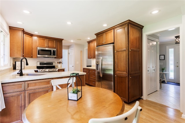 7 Chipping Rdg, Perinton, NY 14450 - kitchen with stainless steel appliances, brown cabinets, recessed lighting, light countertops, and light wood-type flooring