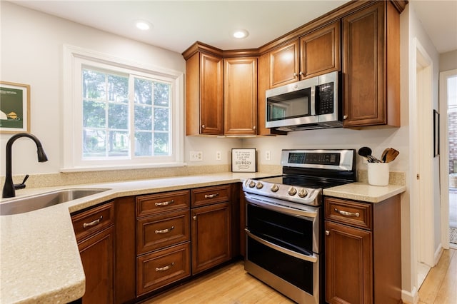 7 Chipping Rdg, Perinton, NY 14450 - kitchen featuring stainless steel appliances, light countertops, light wood-style flooring, recessed lighting, and brown cabinetry