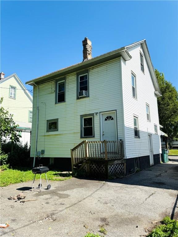 256 Durnan St, Rochester, NY 14621 - rear view of property with a chimney and cooling unit