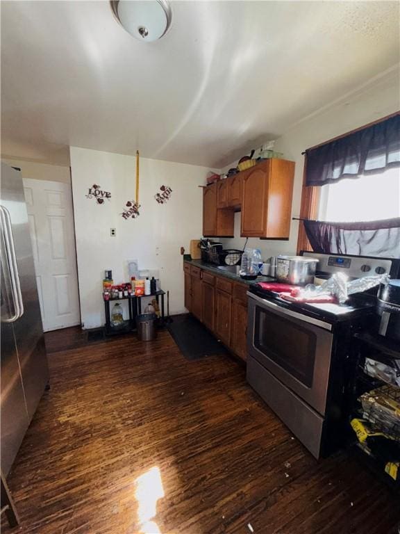 256 Durnan St, Rochester, NY 14621 - kitchen featuring appliances with stainless steel finishes, dark wood-style flooring, brown cabinets, and dark countertops