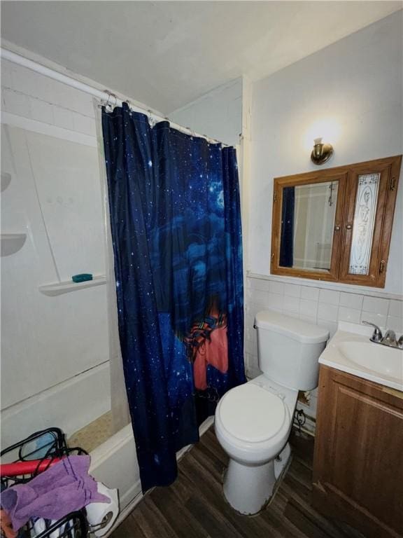 256 Durnan St, Rochester, NY 14621 - full bathroom with wood finished floors, vanity, tile walls, a wainscoted wall, and shower / tub combo with curtain