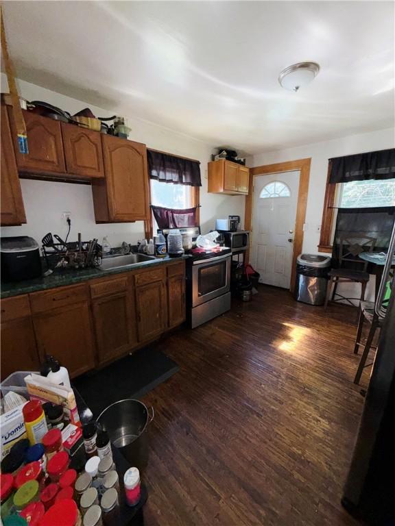 256 Durnan St, Rochester, NY 14621 - kitchen with appliances with stainless steel finishes, dark wood-style floors, brown cabinetry, and dark countertops