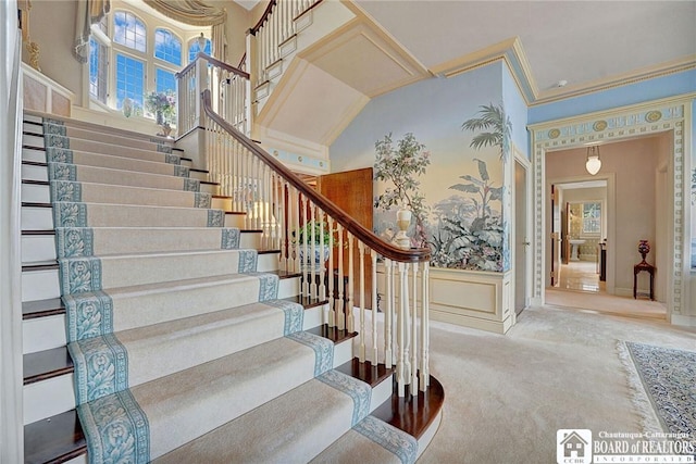 10 Elm Ln, Chautauqua, NY 14722 - staircase featuring plenty of natural light, carpet flooring, ornamental molding, a decorative wall, and wainscoting