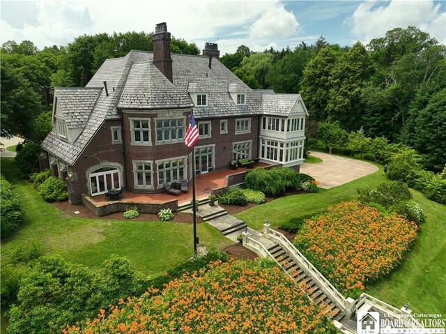 10 Elm Ln, Chautauqua, NY 14722 - back of property featuring a deck, a lawn, a high end roof, and a chimney