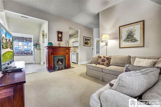 10 Elm Ln, Chautauqua, NY 14722 - carpeted living area featuring baseboards and a lit fireplace