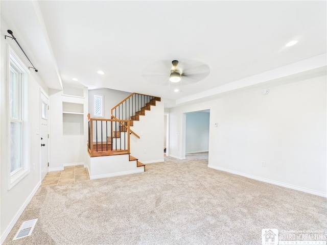 1683 Haskell Rd, Portville, NY 14760 - unfurnished living room with light carpet, ceiling fan, stairs, and recessed lighting