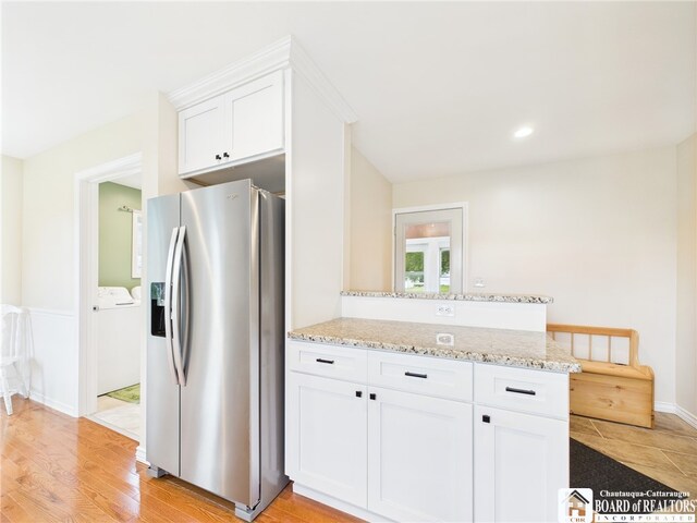1683 Haskell Rd, Portville, NY 14760 - kitchen featuring stainless steel refrigerator with ice dispenser, independent washer and dryer, white cabinetry, light stone countertops, and a peninsula