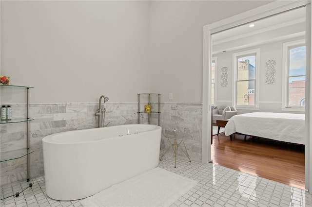 114-116 Main St Unit 114, Milo, NY 14527 - bathroom with a soaking tub, wainscoting, tile walls, and tile patterned flooring