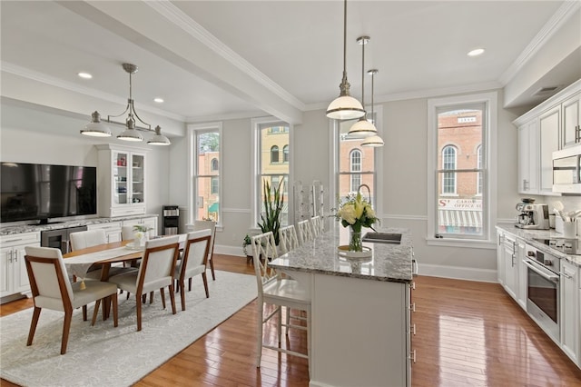 114-116 Main St Unit 114, Milo, NY 14527 - kitchen featuring a center island, light wood-style floors, plenty of natural light, crown molding, and recessed lighting