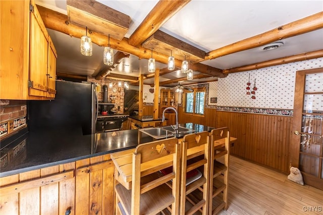 7940 Soft Maple Rd, New Bremen, NY 13327 - kitchen with freestanding refrigerator, beamed ceiling, light wood-style flooring, a wainscoted wall, and dark countertops