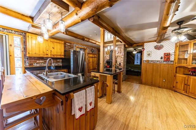 7940 Soft Maple Rd, New Bremen, NY 13327 - kitchen with freestanding refrigerator, ceiling fan, light wood-type flooring, beam ceiling, and brown cabinetry