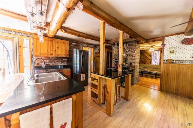 7940 Soft Maple Rd, New Bremen, NY 13327 - kitchen featuring freestanding refrigerator, light wood-type flooring, dark countertops, beam ceiling, and brown cabinetry