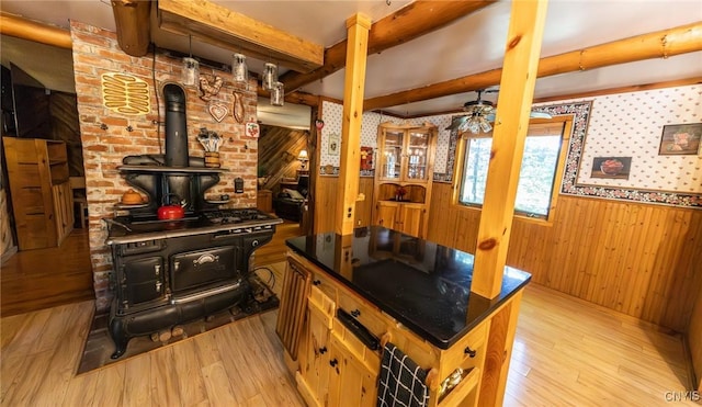 7940 Soft Maple Rd, New Bremen, NY 13327 - kitchen with light wood-style floors, wooden walls, beam ceiling, wainscoting, and a wood stove