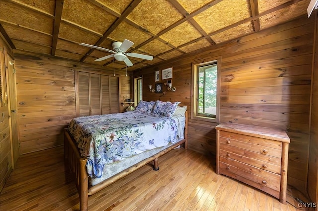 7940 Soft Maple Rd, New Bremen, NY 13327 - bedroom with light wood finished floors, wooden walls, and a ceiling fan
