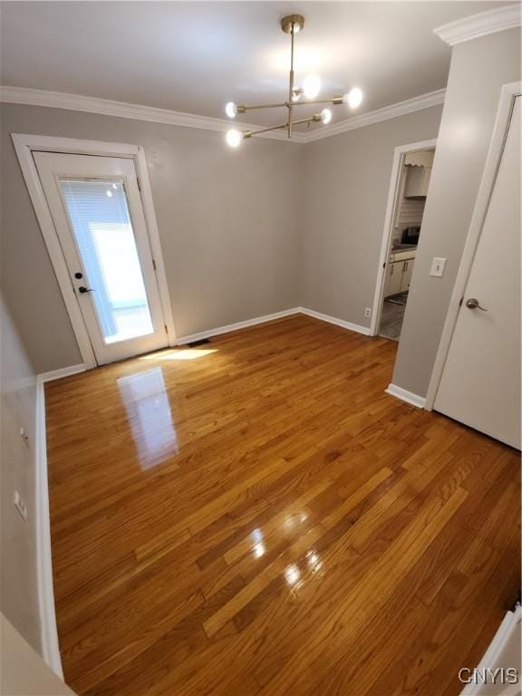 201 Jane Dr, Camillus, NY 13219 - unfurnished room with a chandelier, ornamental molding, and light wood-type flooring