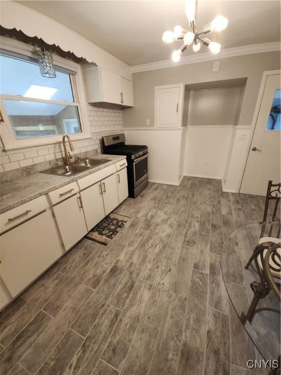 201 Jane Dr, Camillus, NY 13219 - kitchen with gas stove, a chandelier, wood finished floors, and ornamental molding