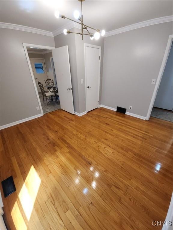 201 Jane Dr, Camillus, NY 13219 - unfurnished living room featuring ornamental molding, light wood-style floors, and a chandelier