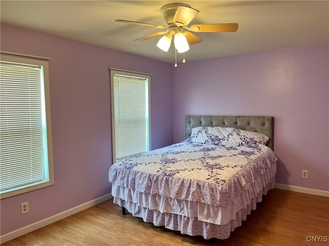 520 Seneca St, Fulton, NY 13069 - bedroom featuring wood finished floors and a ceiling fan