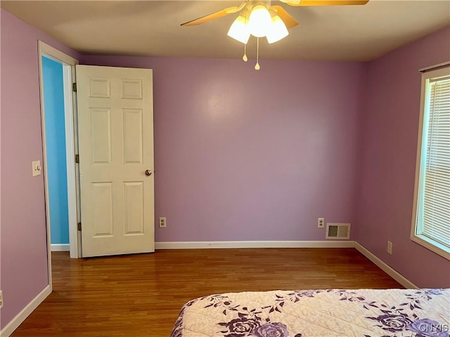 520 Seneca St, Fulton, NY 13069 - unfurnished bedroom featuring wood finished floors and a ceiling fan