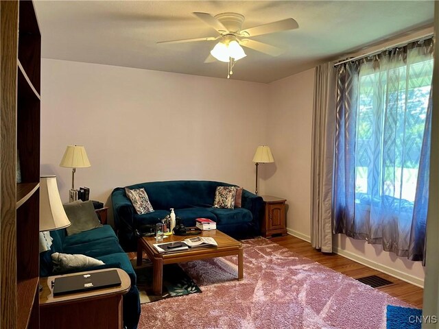 520 Seneca St, Fulton, NY 13069 - living room featuring ceiling fan and wood finished floors