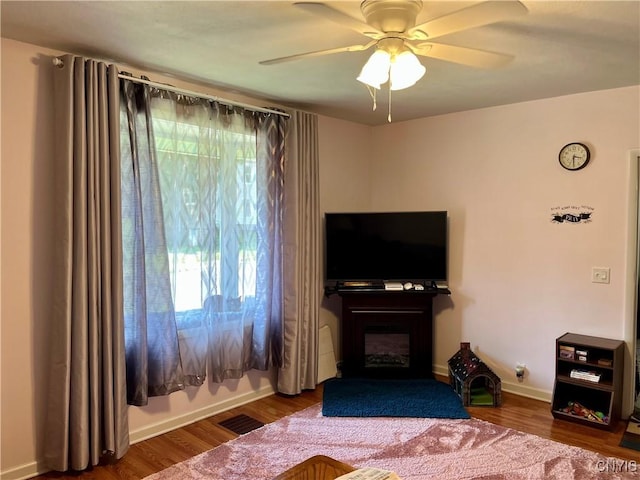 520 Seneca St, Fulton, NY 13069 - living room with wood finished floors, ceiling fan, and a fireplace
