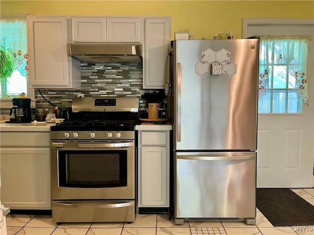 520 Seneca St, Fulton, NY 13069 - kitchen with appliances with stainless steel finishes, range hood, backsplash, and white cabinets