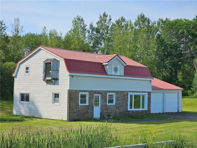7131 State Route 8, Deerfield, NY 13502 - view of side of home featuring a gambrel roof, a yard, stone siding, a metal roof, and a garage