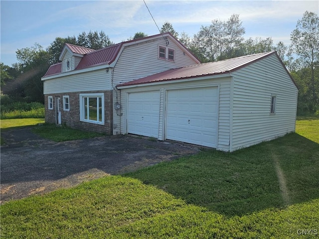 7131 State Route 8, Deerfield, NY 13502 - view of front facade featuring asphalt driveway, a metal roof, an attached garage, a front lawn, and stone siding