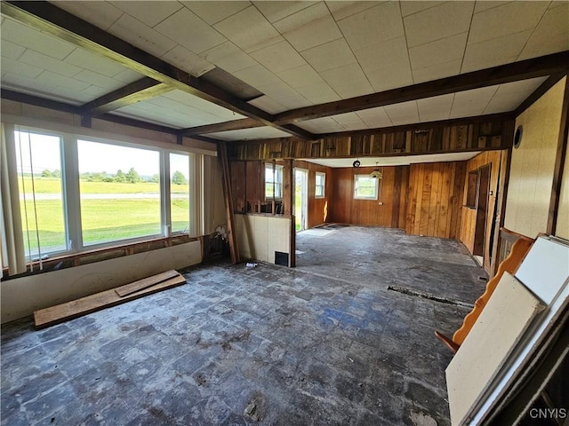 7131 State Route 8, Deerfield, NY 13502 - unfurnished living room featuring wood walls and beam ceiling