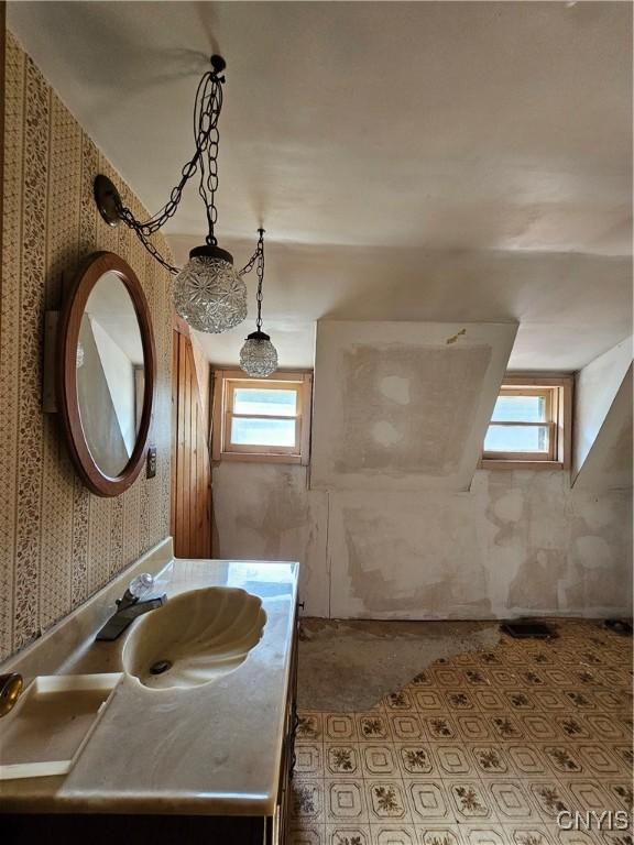 7131 State Route 8, Deerfield, NY 13502 - bathroom with healthy amount of natural light, wallpapered walls, and vanity