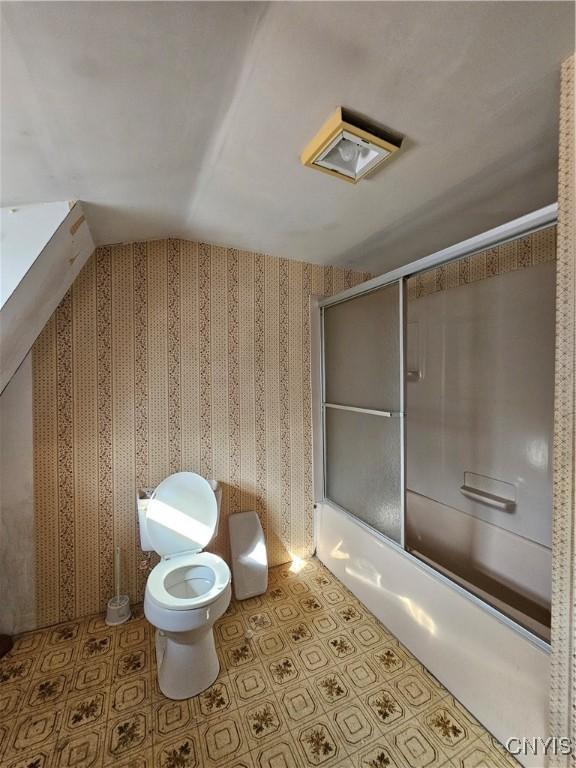7131 State Route 8, Deerfield, NY 13502 - bathroom with shower / bath combination with glass door, lofted ceiling, and wallpapered walls
