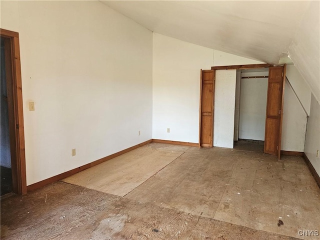 7131 State Route 8, Deerfield, NY 13502 - unfurnished bedroom with vaulted ceiling and baseboards