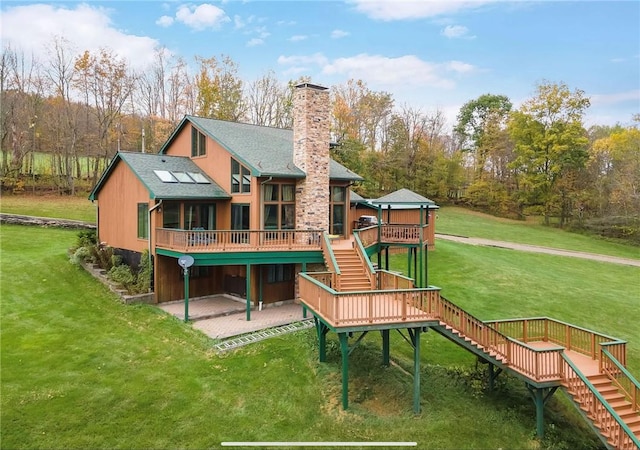 734 Post Rd, Franklin, NY 13775 - back of house with stairway, a wooden deck, a patio, a chimney, and a lawn