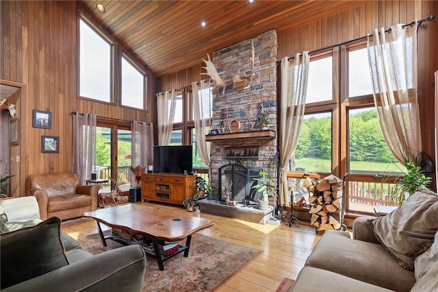 734 Post Rd, Franklin, NY 13775 - living area with wood ceiling, high vaulted ceiling, a fireplace, wood walls, and hardwood / wood-style floors