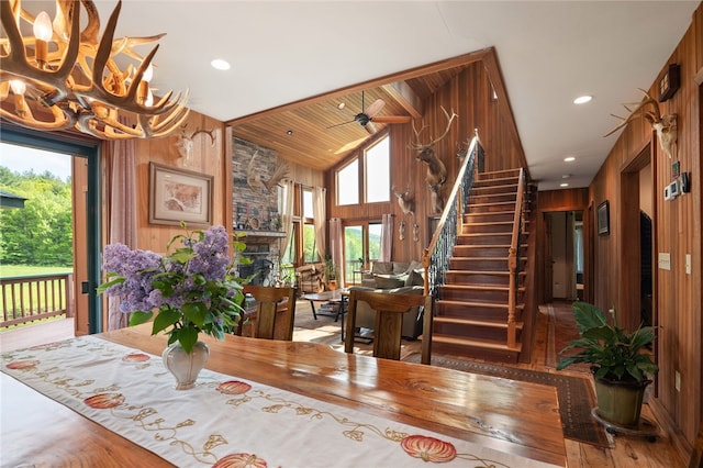 734 Post Rd, Franklin, NY 13775 - dining area with healthy amount of natural light, a chandelier, wooden walls, stairway, and a fireplace