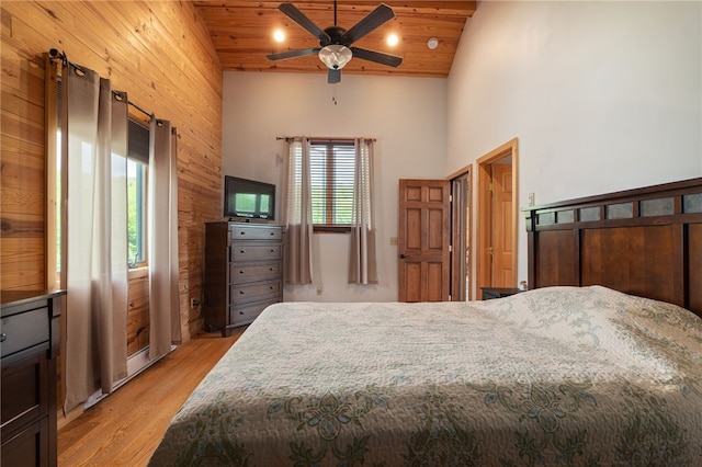 734 Post Rd, Franklin, NY 13775 - bedroom featuring wood walls, light wood-style flooring, a towering ceiling, wooden ceiling, and a ceiling fan
