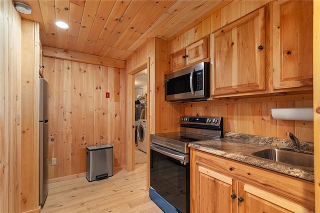 734 Post Rd, Franklin, NY 13775 - kitchen featuring appliances with stainless steel finishes, washer / dryer, wooden walls, light wood finished floors, and wood ceiling